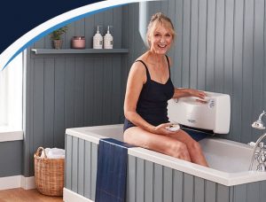 Lady getting into bath using bath lift